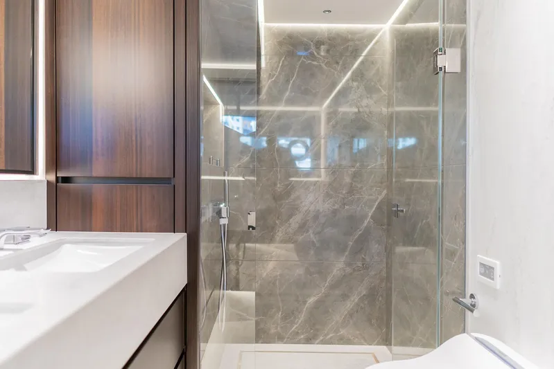  Yacht Photos Pics Luxurious bathroom in 2025 Sunseeker 90 Ocean yacht with marble shower and modern fixtures.
