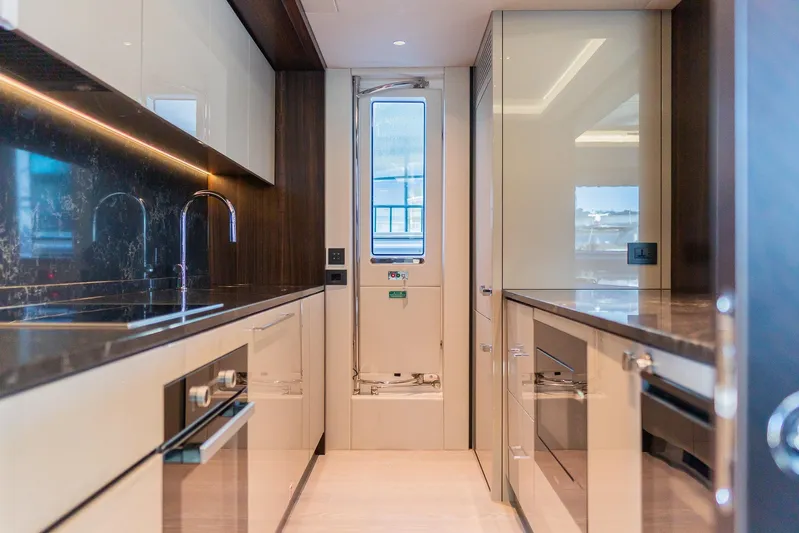  Yacht Photos Pics Luxurious kitchen interior of 2025 Sunseeker 90 Ocean yacht, featuring modern design and sleek finishes.