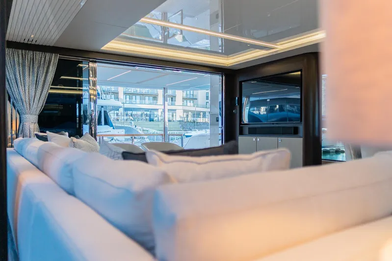  Yacht Photos Pics Luxurious interior of 2025 Sunseeker 90 Ocean yacht with plush seating and marina view.
