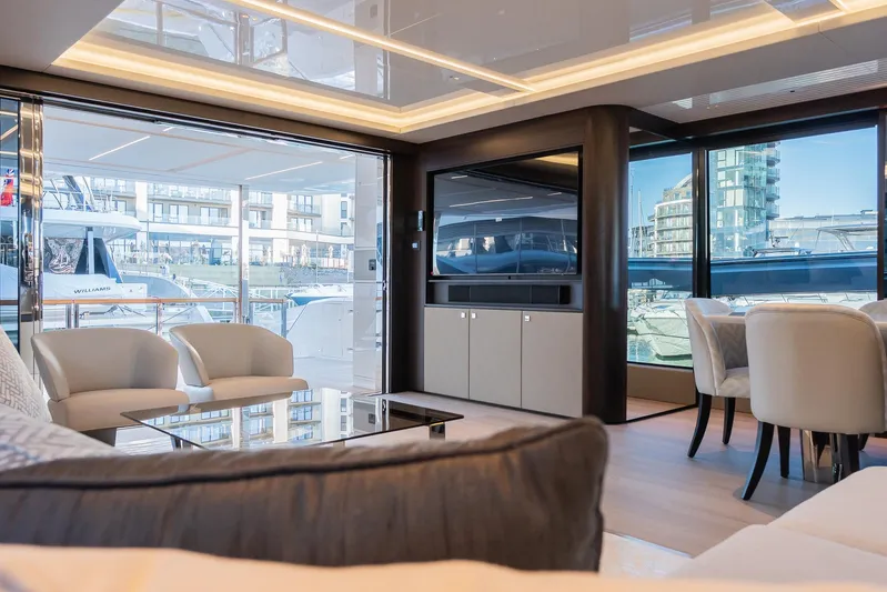  Yacht Photos Pics Luxurious interior of 2025 Sunseeker 90 Ocean yacht with modern seating and large windows.