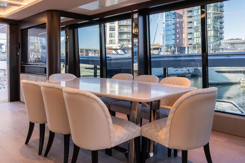  Yacht Photos Pics Luxurious dining area on 2025 Sunseeker 90 Ocean yacht with marina view.