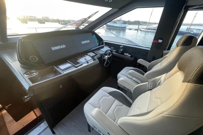  Yacht Photos Pics 2025 Sunseeker 90 Ocean yacht cockpit with Simrad navigation system and luxurious seating.