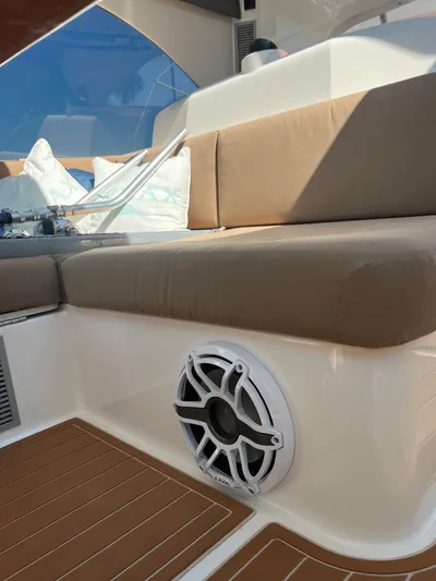 Reel Rodeo Yacht Photos Pics 2014 Maritimo 470 Offshore Convertible boat interior with cushioned seating and speaker.