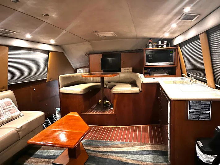 Badfish Yacht Photos Pics Interior of 1998 Ocean Yachts 40 Super Sport with seating, table, and kitchenette.