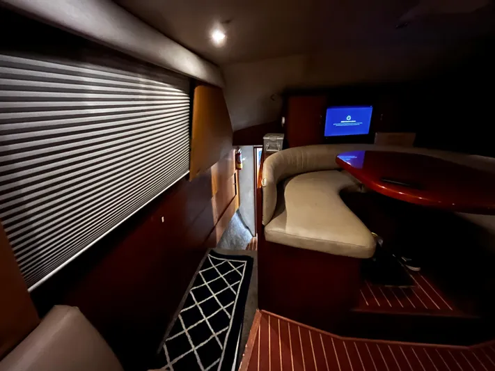 Badfish Yacht Photos Pics Interior of 1998 Ocean Yachts 40 Super Sport with seating area and TV.