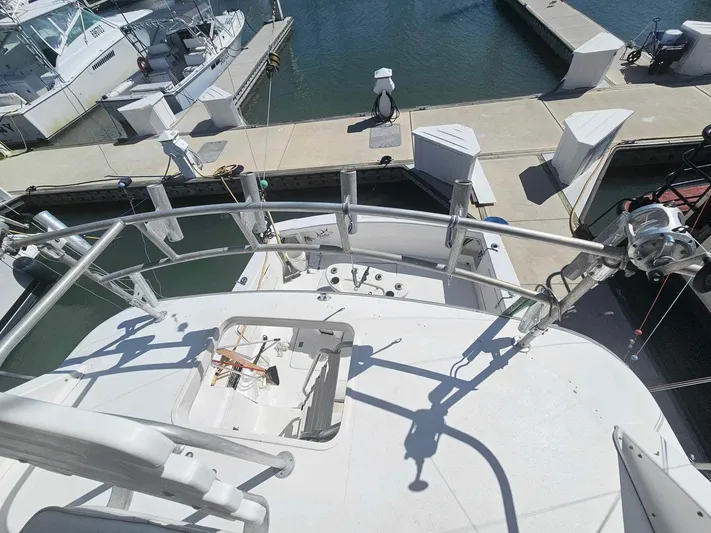 Badfish Yacht Photos Pics 1998 Ocean Yachts 40 Super Sport docked at a marina, view from upper deck.