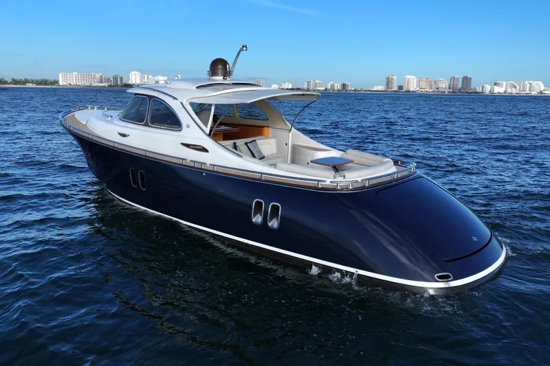 Our Trade Yacht Photos Pics 2013 Zeelander Z44 luxury yacht cruising on open water, city skyline in background.