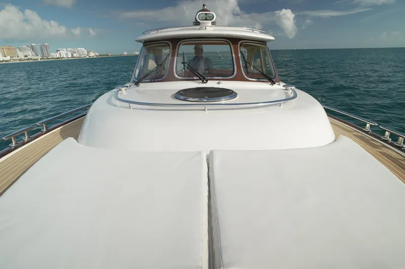 Our Trade Yacht Photos Pics 2013 Zeelander Z44 yacht cruising on open sea with city skyline in background.