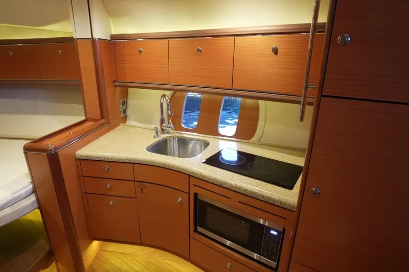 Our Trade Yacht Photos Pics Luxurious 2013 Zeelander Z44 yacht kitchen with modern appliances and elegant wood cabinetry.
