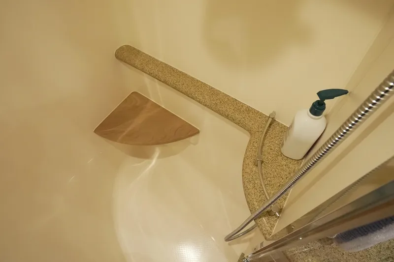 Our Trade Yacht Photos Pics Shower area in 2013 Zeelander Z44 yacht with soap dispenser and wooden seat.