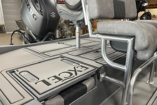 2026 Excel 220 Bay Pro Elite boat interior with Suzuki engine, featuring seating and storage compartments.