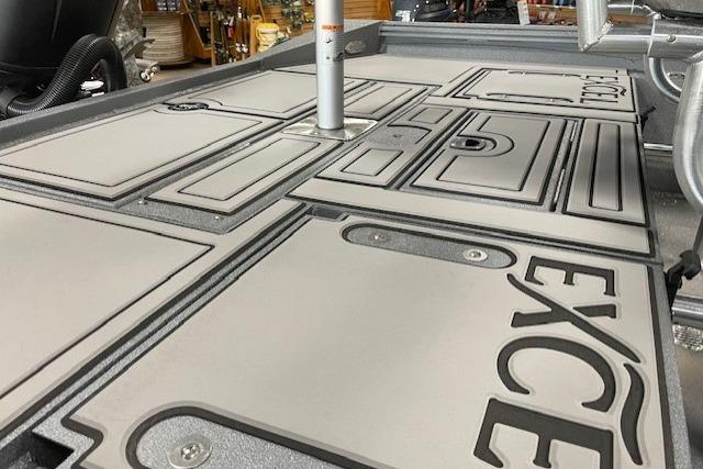 2026 Excel 220 Bay Pro Elite boat deck with storage compartments and logo.