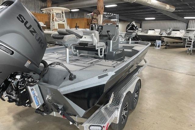 2026 Excel 220 Bay Pro Elite boat with Suzuki engine in showroom.