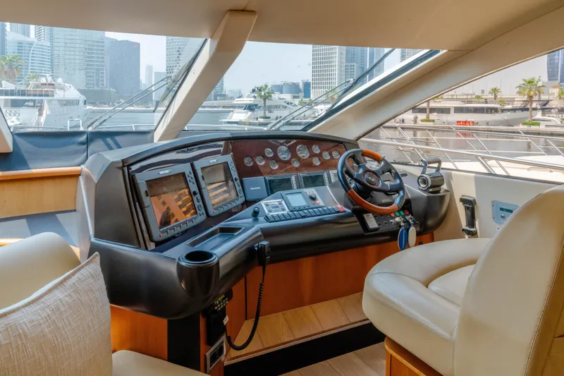  Yacht Photos Pics Luxurious 2008 Sunseeker Manhattan 60 yacht helm with modern navigation equipment and cityscape view.
