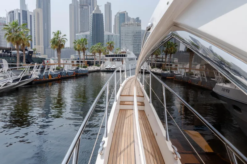  Yacht Photos Pics 2008 Sunseeker Manhattan 60 yacht docked in a modern marina with city skyline.