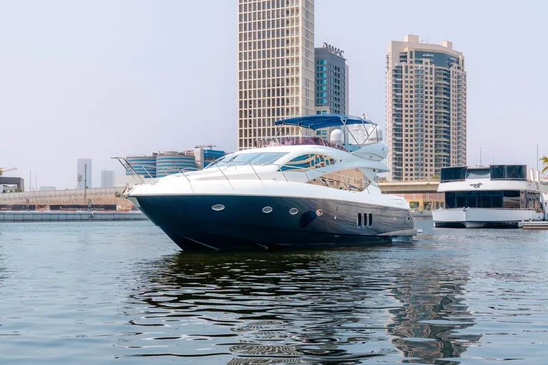  Yacht Photos Pics 2008 Sunseeker Manhattan 60 yacht in urban marina, with modern skyscrapers in the background.