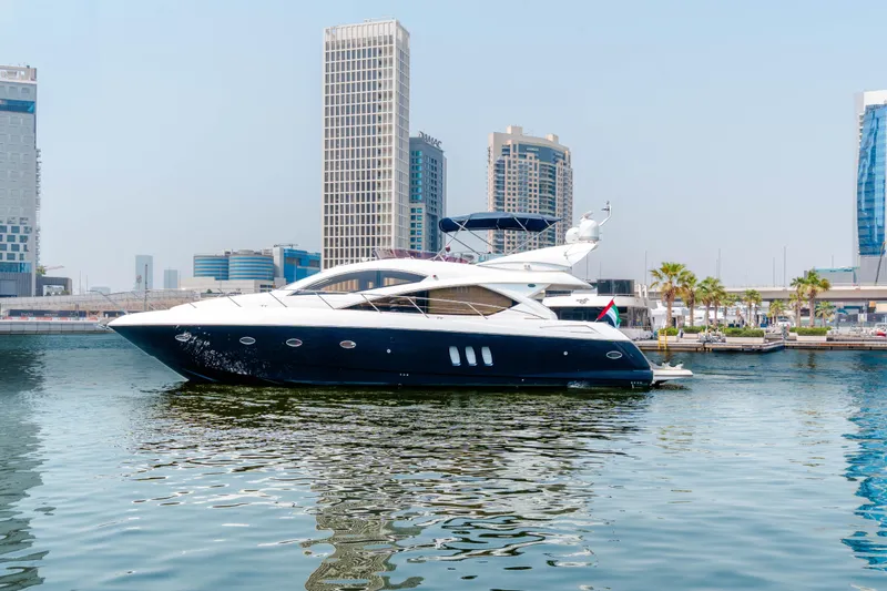  Yacht Photos Pics 2008 Sunseeker Manhattan 60 yacht docked in urban marina with skyscrapers in background.