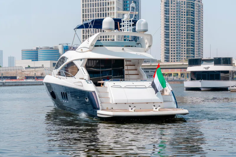 Yacht Photos Pics 2008 Sunseeker Manhattan 60 yacht in urban marina, UAE flag displayed.