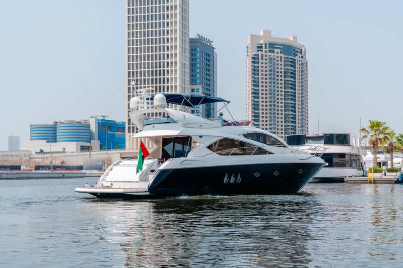  Yacht Photos Pics 2008 Sunseeker Manhattan 60 yacht cruising in urban waterfront setting.