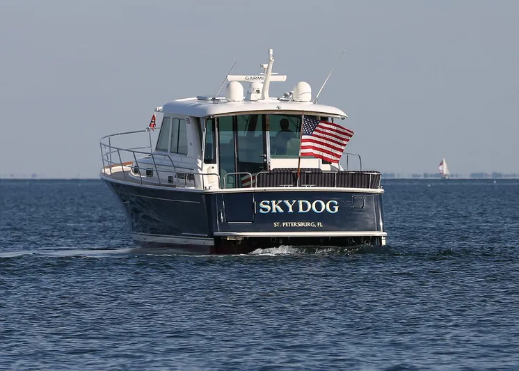 Skydog Yacht Photos Pics Sabre 48 Salon Express 2017 boat "SKYDOG" cruising on open water with American flag.