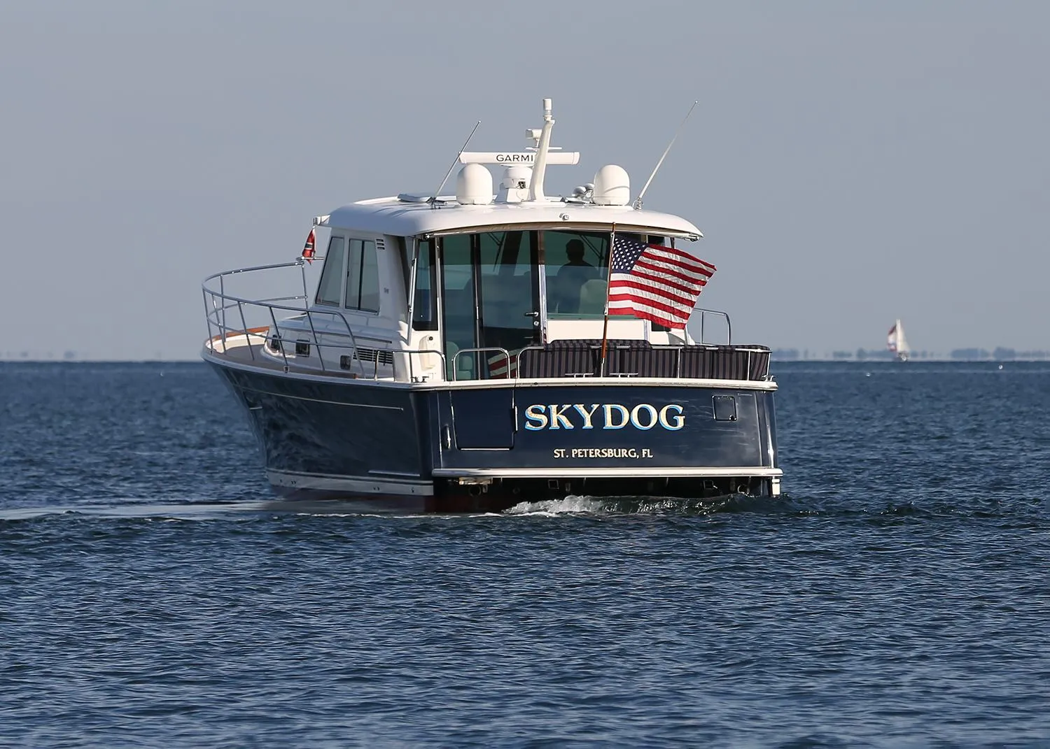 Sabre 48 Salon Express 2017 boat "SKYDOG" cruising on open water with American flag.