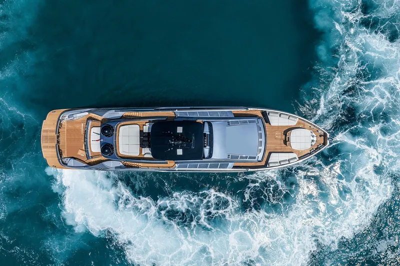  Yacht Photos Pics Aerial view of 2025 Pershing GTX116 yacht cruising through blue ocean waters.