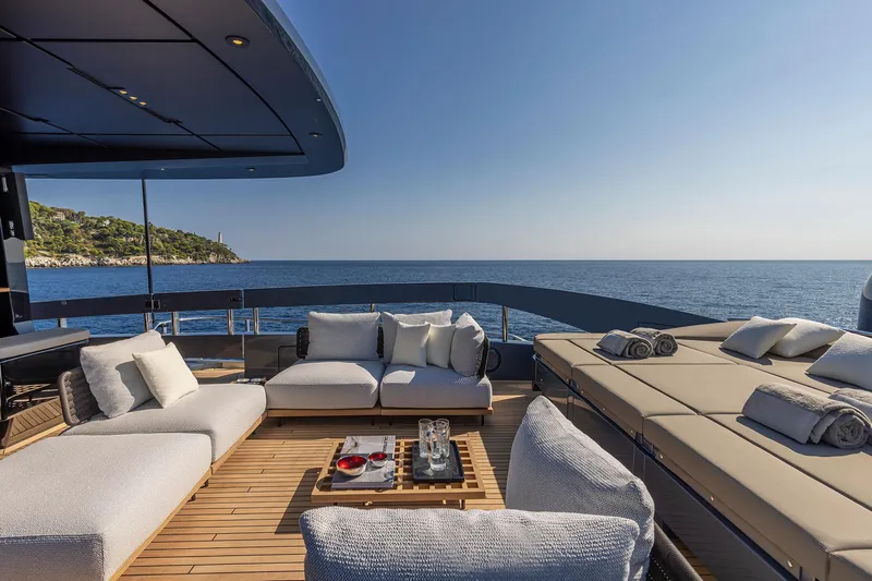  Yacht Photos Pics Luxurious deck of 2025 Pershing GTX116 yacht with ocean view and comfortable seating.
