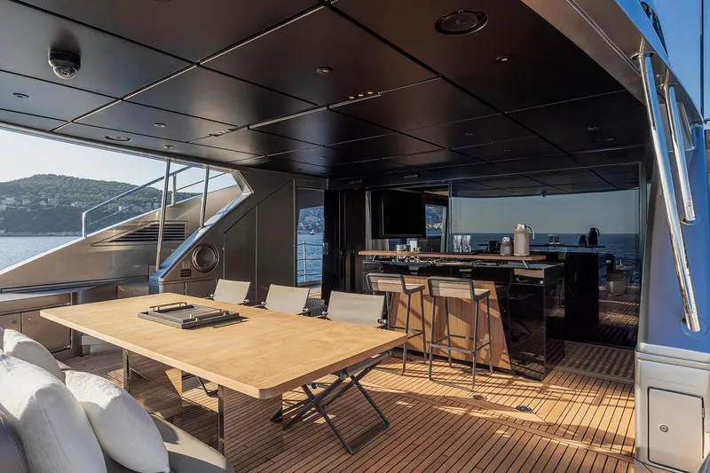  Yacht Photos Pics Luxurious 2025 Pershing GTX116 yacht deck with elegant dining and bar area.