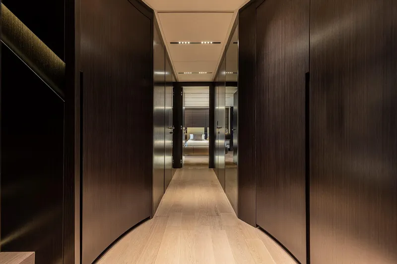  Yacht Photos Pics Luxurious interior hallway of 2025 Pershing GTX116 yacht with sleek wooden finishes.