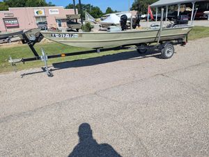 1983 Lowe 16 Lake Jon boat on trailer, parked outdoors in a lot.
