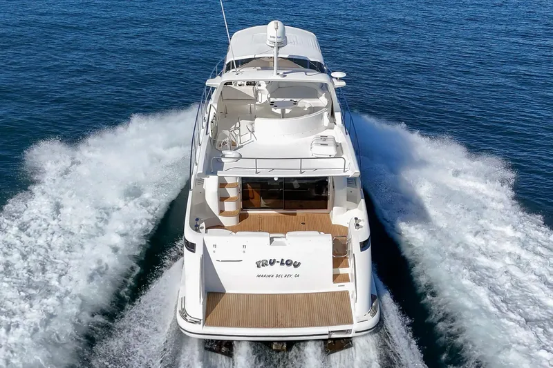  Yacht Photos Pics 2002 Azimut 58 yacht cruising on open water, rear view.