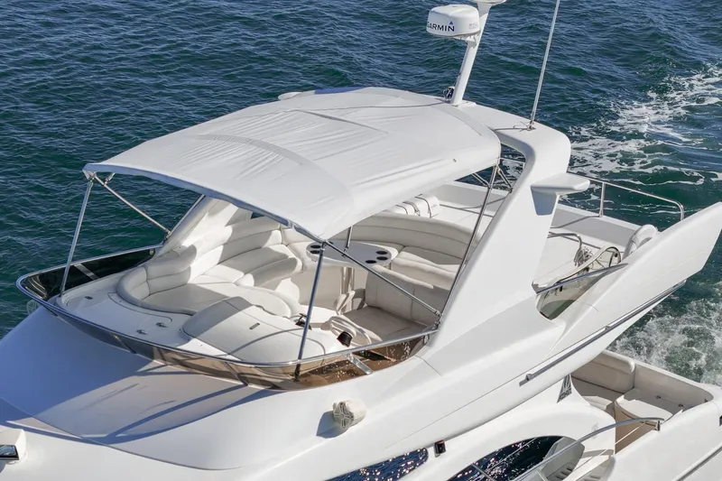  Yacht Photos Pics Luxury 2002 Azimut 58 yacht cruising on open water, featuring sleek design and spacious deck.