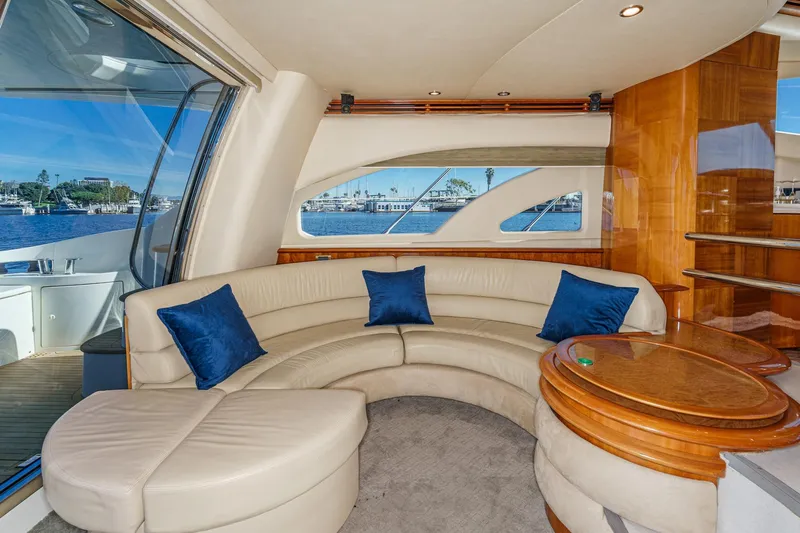  Yacht Photos Pics Luxurious interior of 2002 Azimut 58 yacht with curved seating and blue cushions.