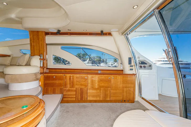 Yacht Photos Pics Luxurious interior of a 2002 Azimut 58 yacht with elegant wood finishes and plush seating.