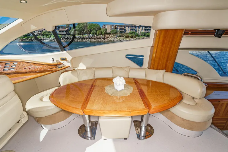  Yacht Photos Pics Luxurious interior of 2002 Azimut 58 yacht with elegant seating and wooden table.