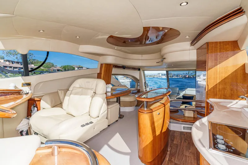 Yacht Photos Pics Luxurious interior of a 2002 Azimut 58 yacht with elegant wood finishes and plush seating.