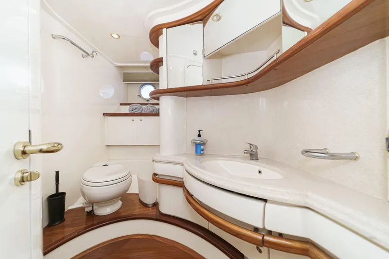  Yacht Photos Pics Luxurious bathroom interior of a 2002 Azimut 58 yacht, featuring elegant wood accents.