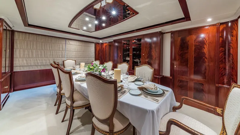 Bella Yacht Photos Pics Luxurious dining room on 2005 Sensation Yachts Sensation 177, featuring elegant table setting and wood paneling.