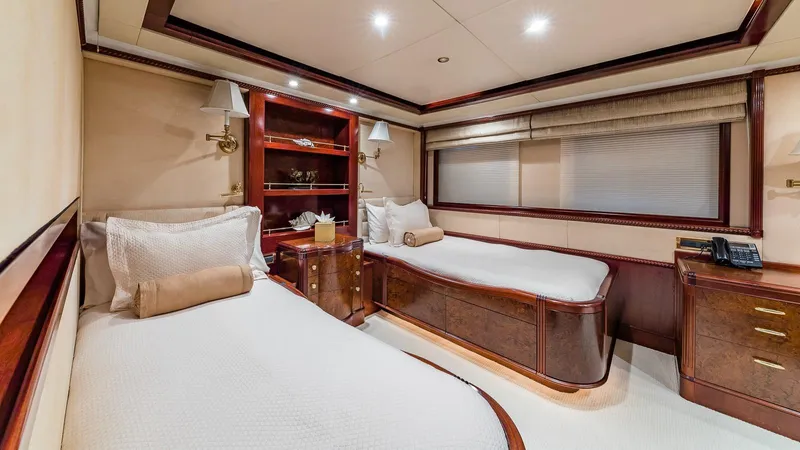 Bella Yacht Photos Pics Luxurious twin bedroom on 2005 Sensation Yachts Sensation 177, featuring elegant wood finishes.