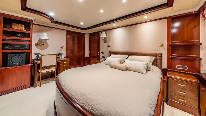 Bella Yacht Photos Pics Luxurious bedroom interior of 2005 Sensation Yachts Sensation 177, featuring elegant wood finishes.