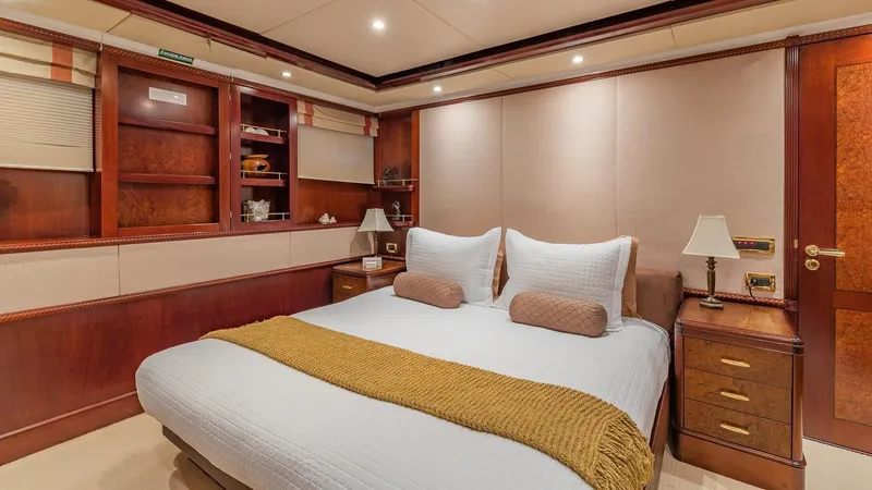 Bella Yacht Photos Pics Luxurious bedroom in 2005 Sensation Yachts Sensation 177, featuring elegant wood finishes.