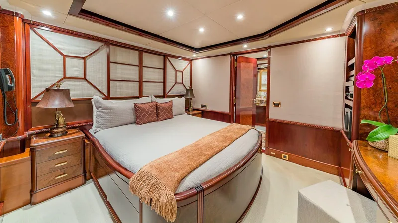 Bella Yacht Photos Pics Luxurious bedroom interior on 2005 Sensation Yachts Sensation 177, featuring elegant wood finishes.