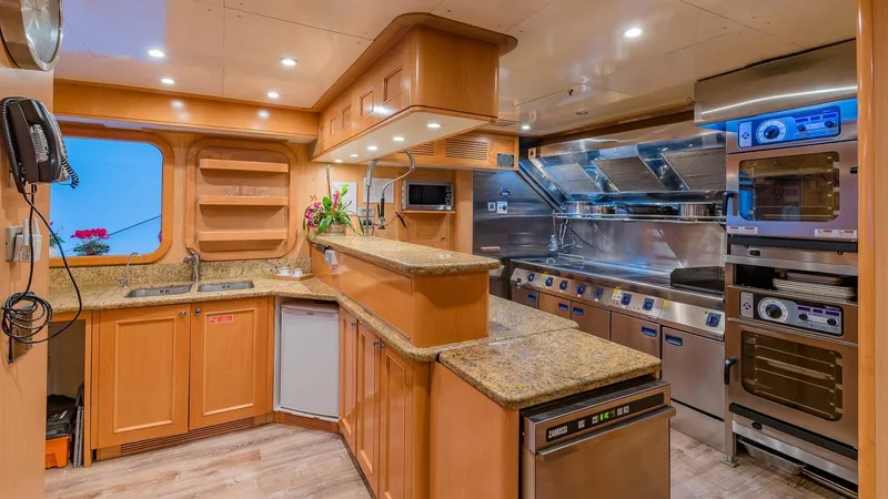 Bella Yacht Photos Pics Luxurious kitchen in 2005 Sensation Yachts Sensation 177, featuring modern appliances and wood cabinetry.