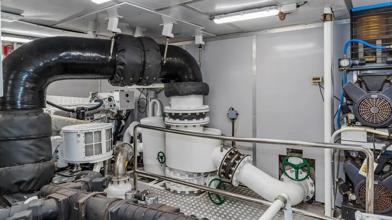 Bella Yacht Photos Pics Engine room of 2005 Sensation Yachts Sensation 177 with industrial piping and machinery.