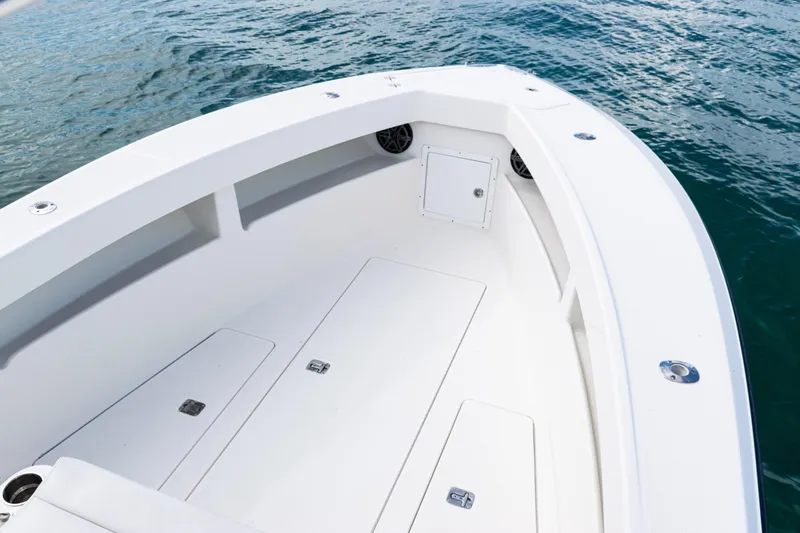  Yacht Photos Pics 2018 SeaVee 29 boat deck with storage compartments, floating on calm water.