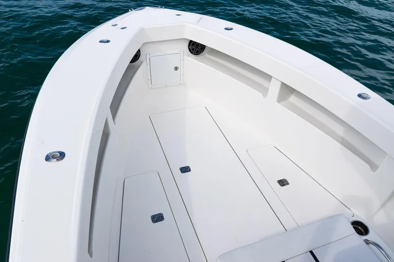  Yacht Photos Pics 2018 SeaVee 29 boat deck with storage compartments, floating on blue water.