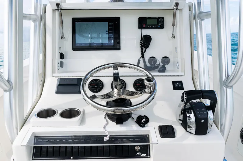  Yacht Photos Pics 2018 SeaVee 29 boat dashboard with steering wheel, navigation screen, and controls.