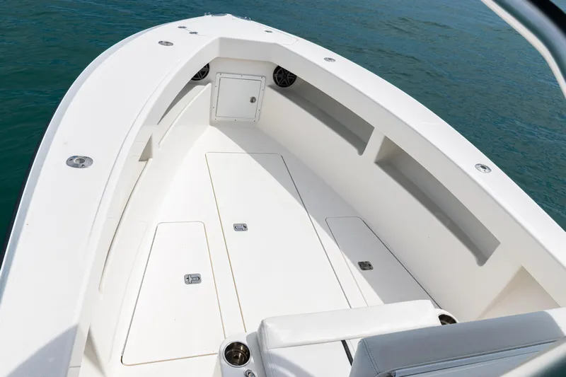  Yacht Photos Pics 2018 SeaVee 29 boat deck with storage compartments, surrounded by blue water.