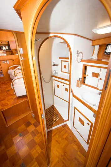 Seascape Yacht Photos Pics 1989 Cheoy Lee 53 yacht interior with wooden cabinetry and compact bathroom.
