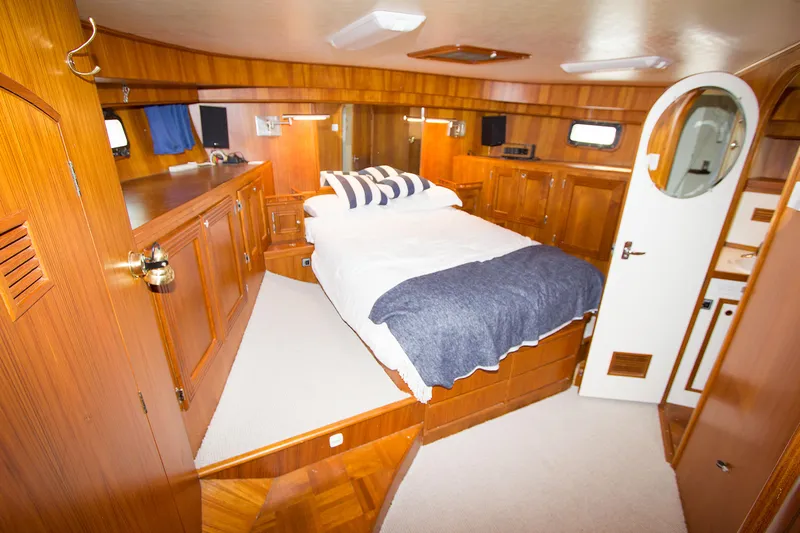Seascape Yacht Photos Pics Luxurious 1989 Cheoy Lee 53 yacht cabin with wood paneling and cozy bed.